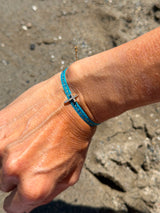 Pulsera tela cruz turquesa
